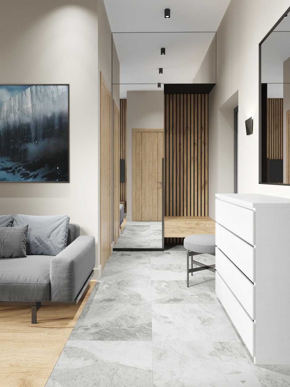 В квартире обустроено много мест для хранения. В прихожей находятся открытая и закрытая секции для одежды и обуви, а также ящик-скамья.